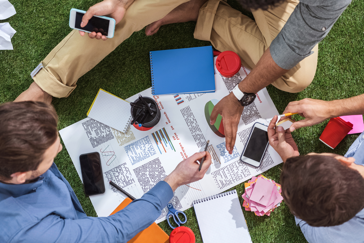 overhead view of business people working on new business plan, business teamwork